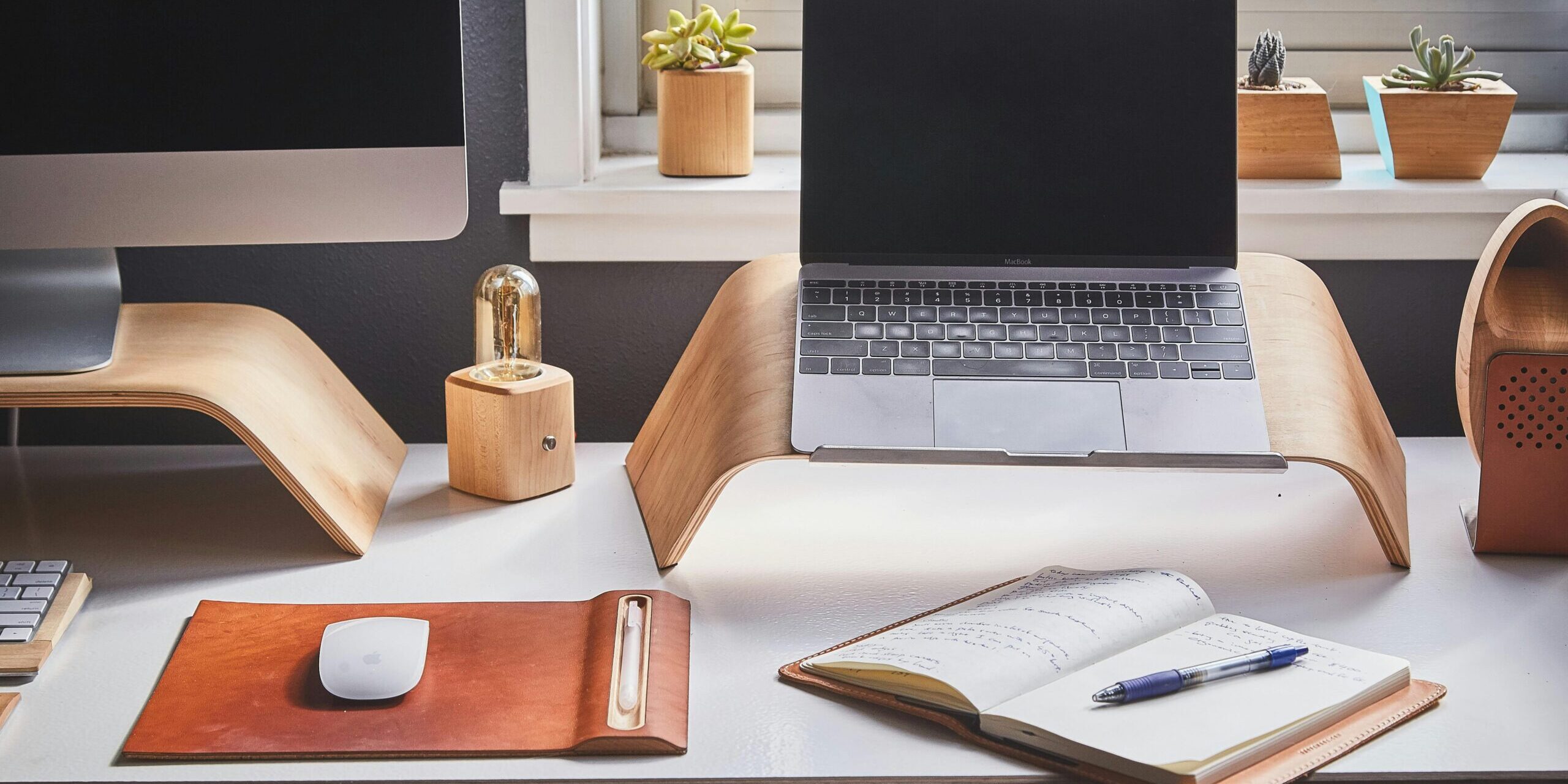 Free A stylish and contemporary home office setup with laptop and desk accessories. Stock Photo