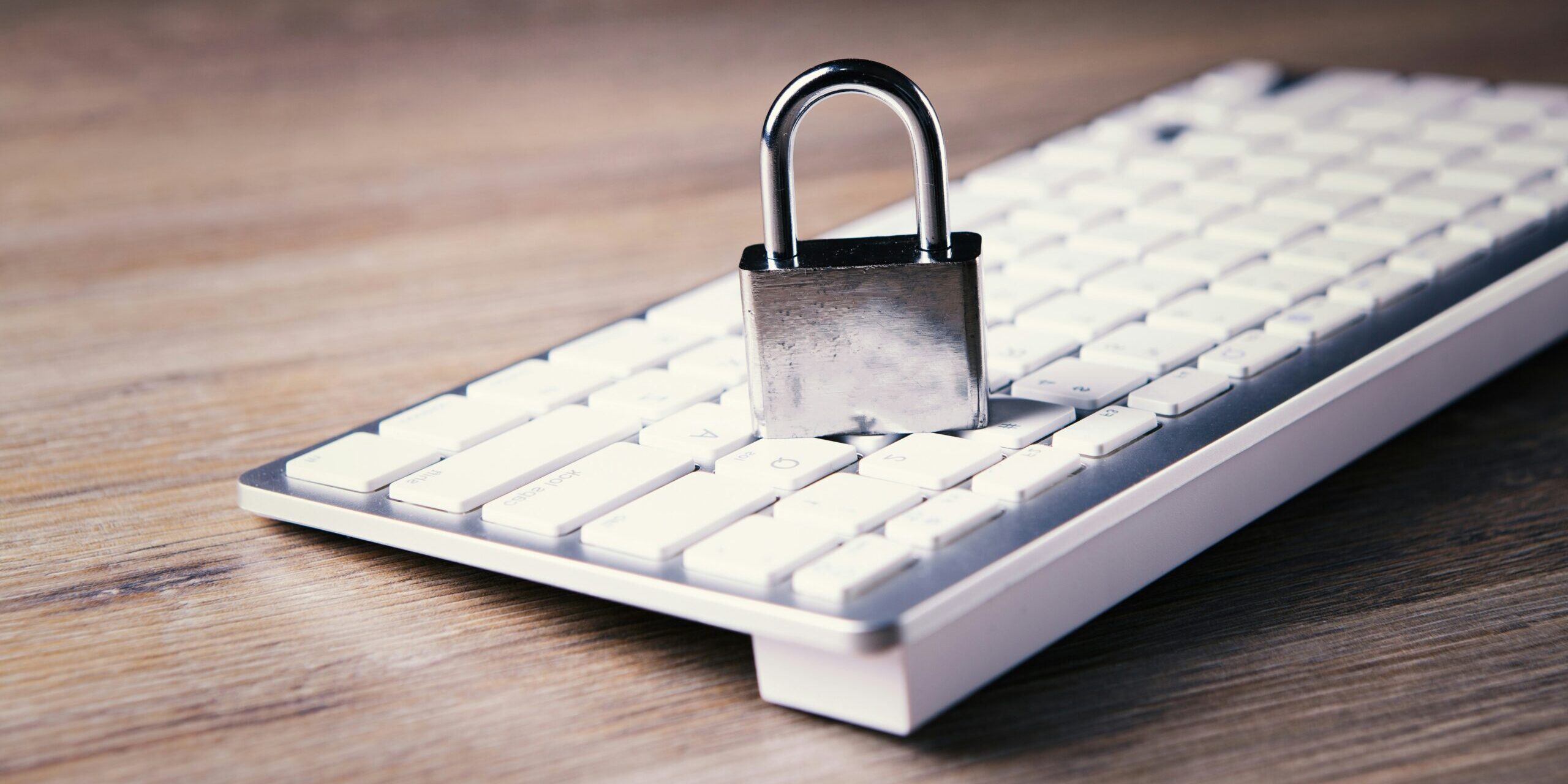 Remote-Work-Security-Revisited_-Advanced-Strategies-for-Protecting-Your-Business-in-2025-scaled.jpg a computer keyboard with a padlock on top of it