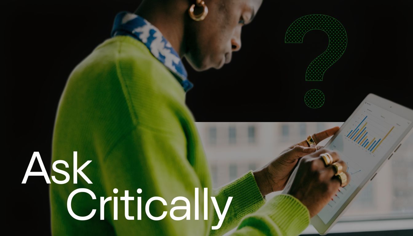 A person in a bright green sweater examining data visualizations on a tablet with a question mark.