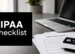 HIPAA Checklist sign on a desk beside HIPAA compliance forms, a security card, and a laptop.