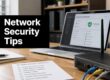 Hero image for a network security tips article: a laptop with a security dashboard on screen, a black sign reading 'Network Security Tips' on the left, and a router with cables on a wooden desk beside a checklist.