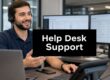 Support agent with headset at a desk, two monitors showing ticket queues, and a 'Help Desk Support' sign in the foreground.