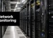 Data center with tall server racks; a black banner reads 'Network Monitoring' in white text on the left.