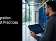 IT professional in a server room holds a tablet showing a network diagram beside 'Migration Best Practices'.