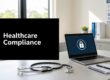 Sign reading 'Healthcare Compliance' on a desk in a medical office, with a laptop showing a lock icon nearby and a stethoscope on the table.