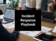 A meeting scene with laptops and papers on a wooden table; a black card in the center reads 'Incident Response Playbook'.