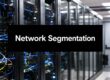 Server racks in a data center with blue cables and a bold banner reading 'Network Segmentation'.