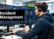 IT support analyst with headset reviewing a multi-monitor incident management dashboard.