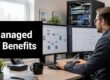Man sits at a desk with two computer monitors displaying network diagrams; large text on the left reads 'Managed IT Benefits'.