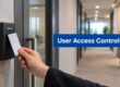 Person holds a white access card up to a door reader in a hallway; blue sign reads 'User Access Controls' nearby.